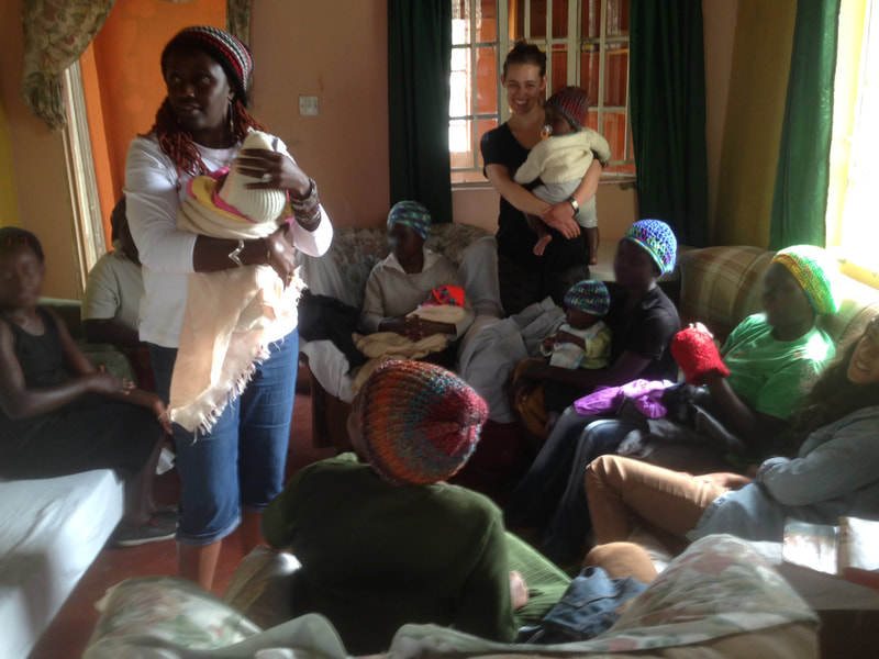 Our founder, Nyakio, with the survivors at AAH and their babies.